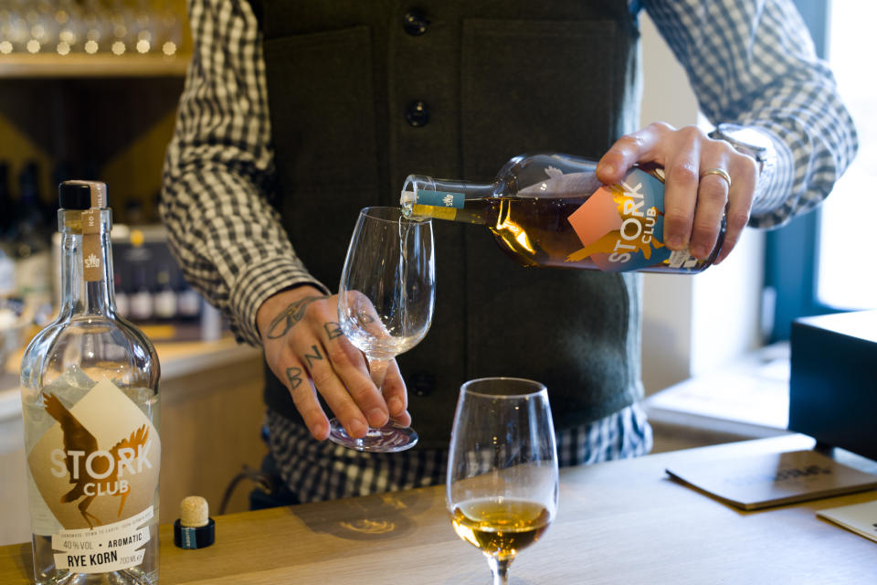 In this Thursday, Feb. 28, 2019 photo, Bastian Heuser co-owner of German whiskey maker Spreewood Distillery tests rey whiskey during an interview with the Associated Press in Schlepzig, Germany. (AP Photo/Markus Schreiber)