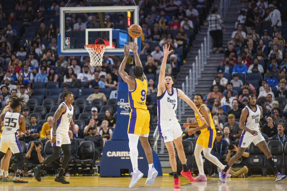 Los Angeles Lakers guard Bronny James (9) shoots past Sacramento Kings forward Jay Neagle (7) during the first half of an NBA summer league basketball game against in San Francisco, Saturday, July 6, 2024. (AP Photo/Nic Coury)