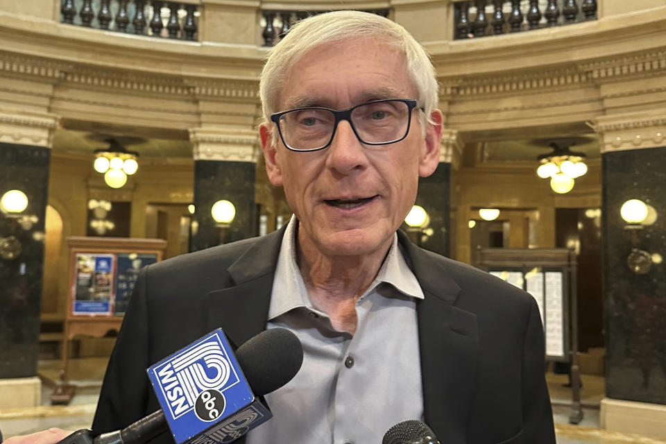 FILE - Wisconsin Gov. Tony Evers speaks with reporters in the state Capitol, Tuesday, Oct. 17, 2023, in Madison, Wisc. Joshua Pleasnick, accused of bringing guns to the Wisconsin state Capitol building and demanding to see Gov. Tony Evers, can go free on a signature bond but can't come near the governor or his family until his case is resolved, a court commissioner ordered Thursday, Oct 19, 2023. (AP Photo/Scott Bauer, File)