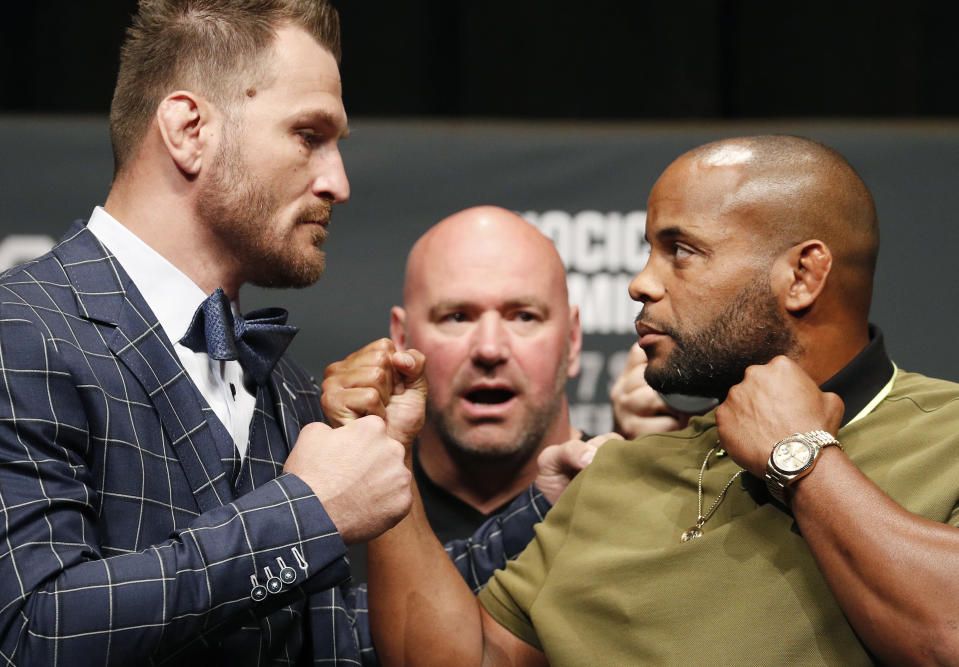 Stipe Miocic, left, and Daniel Cormier pose during a news conference for UFC 226, Thursday, July 5, 2018, in Las Vegas. The two are scheduled to fight in a heavyweight title fight Saturday in Las Vegas. (AP Photo/John Locher)