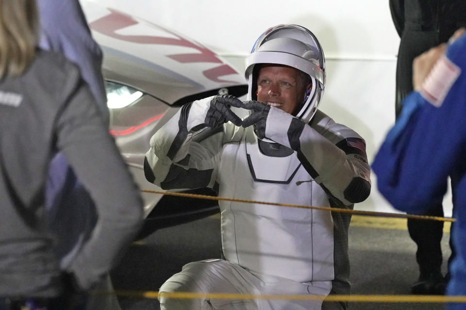 NASA astronaut Bob Hines makes a hand gesture to family members after leaving the Operations and Checkout building and a trip to Launch Complex 39-A Wednesday, April 27, 2022, at the Kennedy Space Center in Cape Canaveral, Fla. Four astronauts will fly on SpaceX's Crew-4 mission to the International Space Station. (AP Photo/John Raoux)