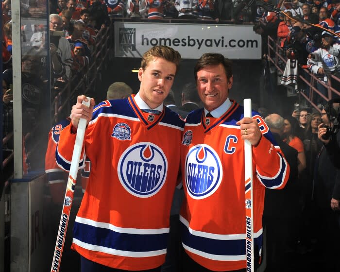Connor McDavid #97 of the Edmonton Oilers and Wayne Gretzky of the Edmonton Oilers Alumni pose for a photo
