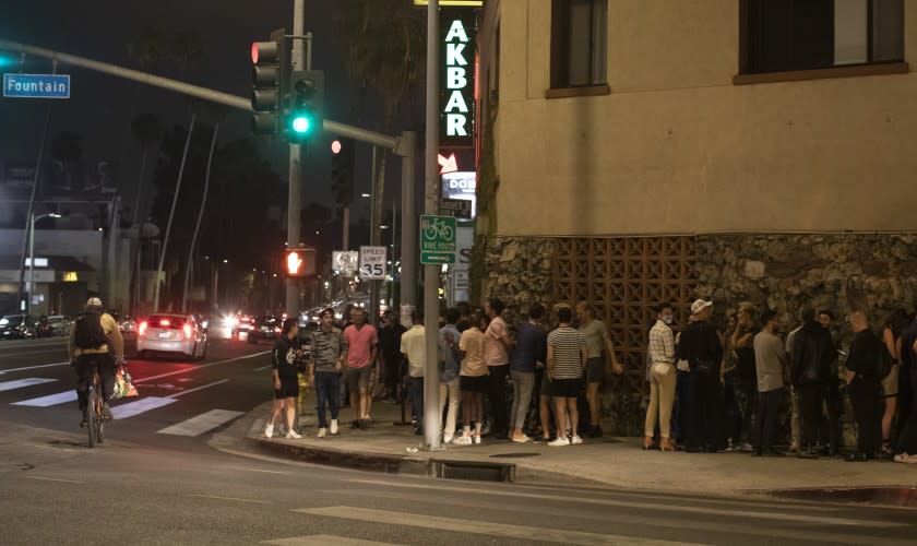 LOS ANGELES, CA - JUNE 19: Patrons wait to enter Akbar on Saturday, June 19, 2021 following its reopening. The bar is a longtime fixture of LA's gay disco scene and was in danger of closing, but after a successful fundraiser the club is back in action. (Myung J. Chun / Los Angeles Times)