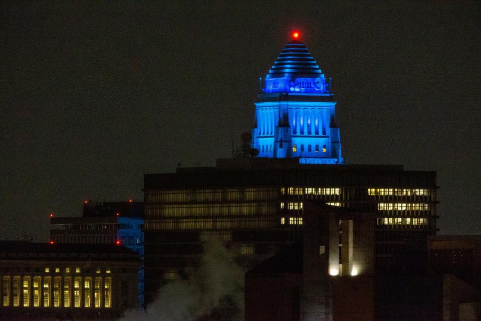 Los Angeles City Hall building is illuminated blue in downtown Los Angeles on April 9, 2020.