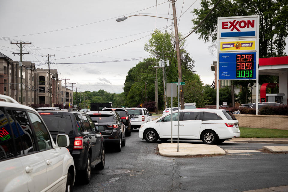 Motorists line up at an EXXON station selling gas at $3.29 per gallon soon after it's fuel supply was replenished in Charlotte, North Carolina on May 12, 2021. - Fears the shutdown of the Colonial Pipeline because of a cyberattack would cause a gasoline shortage led to some panic buying and prompted US regulators on May 11, 2021 to temporarily suspend clean fuel requirements. While it remained unclear the degree to which supplies would be affected, drivers lined up to fill their tanks at gas stations in the southeast, with some carrying extra containers amid fears of fuel scarcity. (Photo by Logan Cyrus / AFP) (Photo by LOGAN CYRUS/AFP via Getty Images)