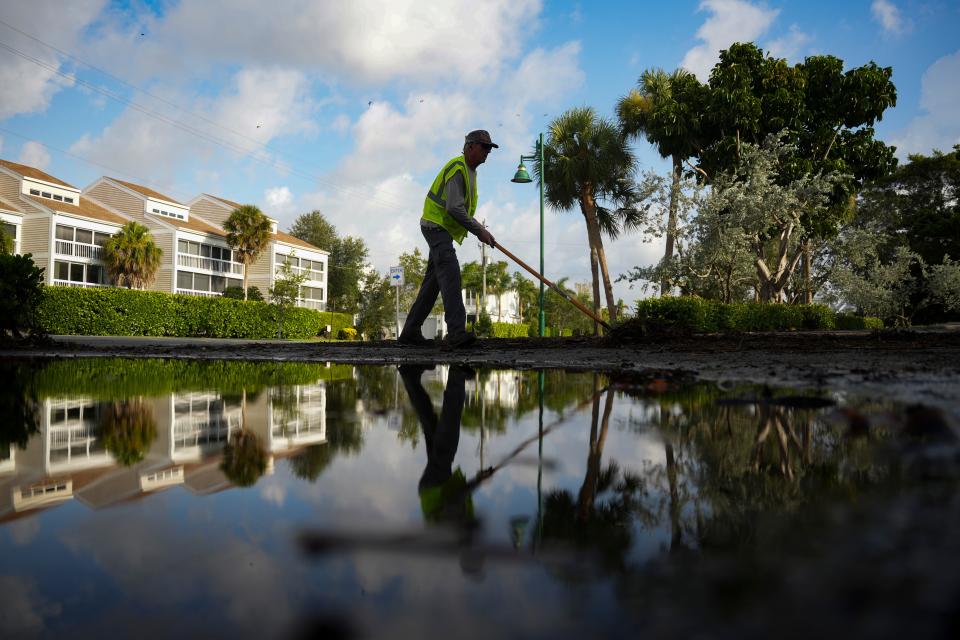 Kurt Van De Wouw of the community services department sweeps up debris from trees after Hurricane Idalia in Naples on Wednesday, Aug. 30, 2023.