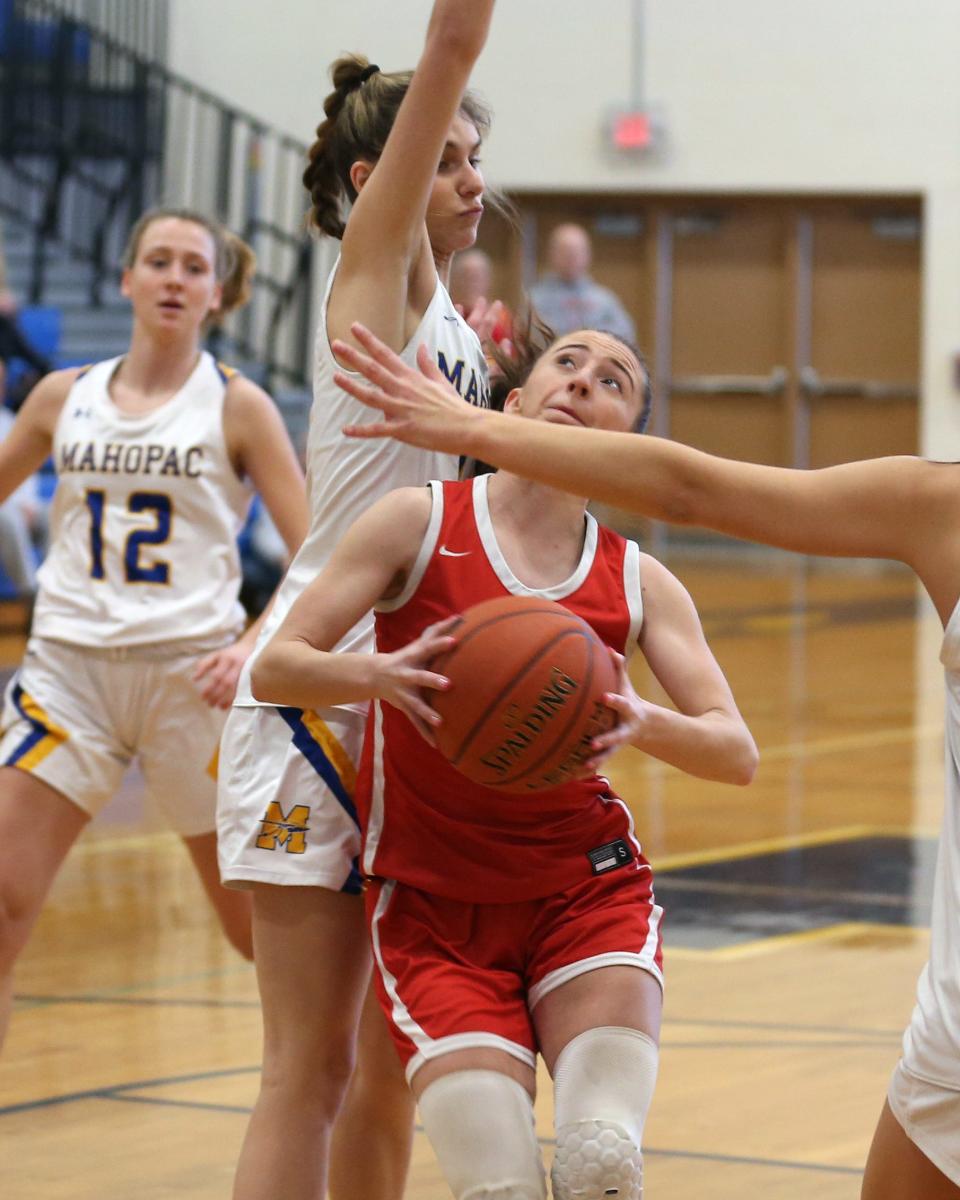Somers Ava Giudice (2) tries to go up for a shot in front of Mahopac's Lauren Bebermen (11) during girls basketball playoff action at Mahopac High School Feb. 18, 2023.