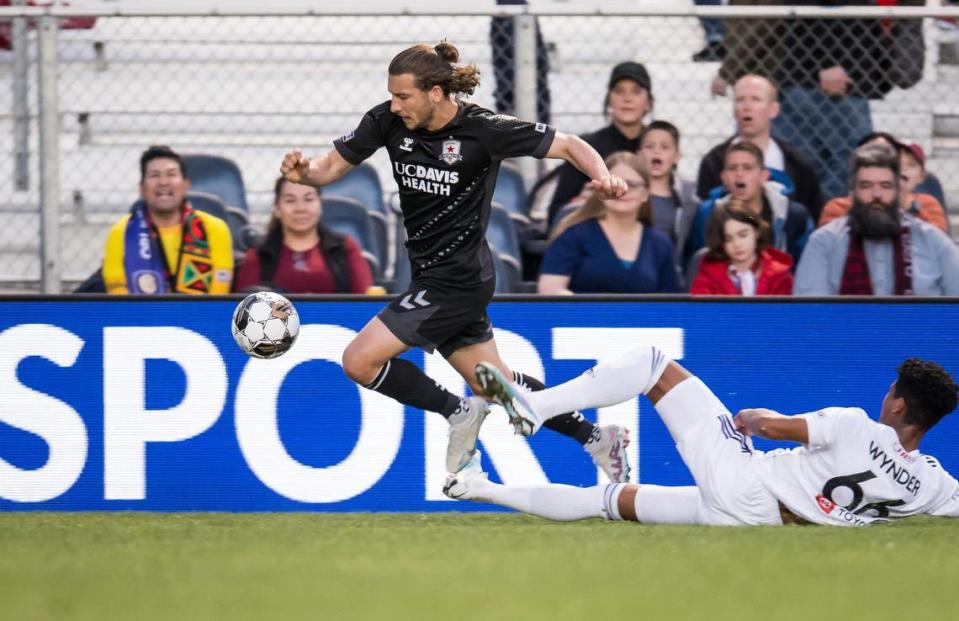 Sacramento Republic FC forward Russell Cicerone (11), left, evades Louisville City FC defender Joshua Wynder (66) and crosses the ball for teammate Jack Gurr (2) to score during the first half of the USL soccer game Saturday, April 1, 2023, at Heart Health Park. Sac Republic shut out Louisville 5-0.