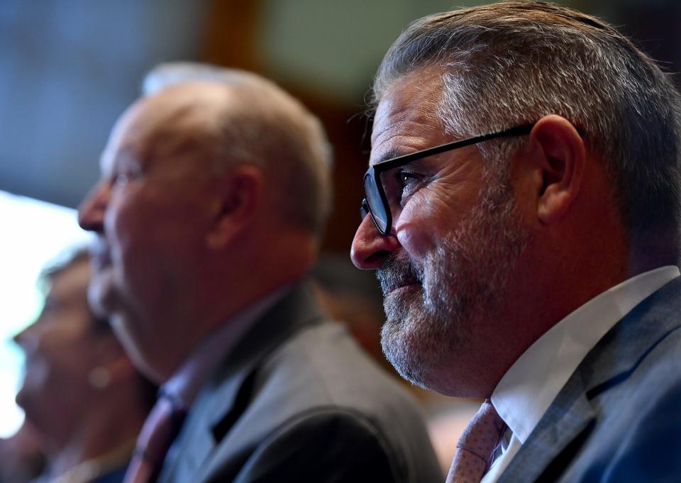 Former Worcester City Manager Michael O'Brien listens as his two daughters talk about him during the unveiling ceremony for his portrait Friday at City Hall.