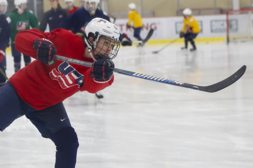 In this Monday, Nov. 4, 2019, photo, Alexandra Carpenter goes through drills while playing with the U.S. Women's National hockey team in Cranberry Township, Butler County, Pa., ahead of scheduled exhibition games against Canada. Carpenter, college hockey's top player in 2015 and daughter of former NHL star Bobby Carpenter, is also leading Russia's Women's Hockey League in scoring while playing for the Chinese-based Shenzhen KRS Vanke Rays. (AP Photo/Keith Srakocic)