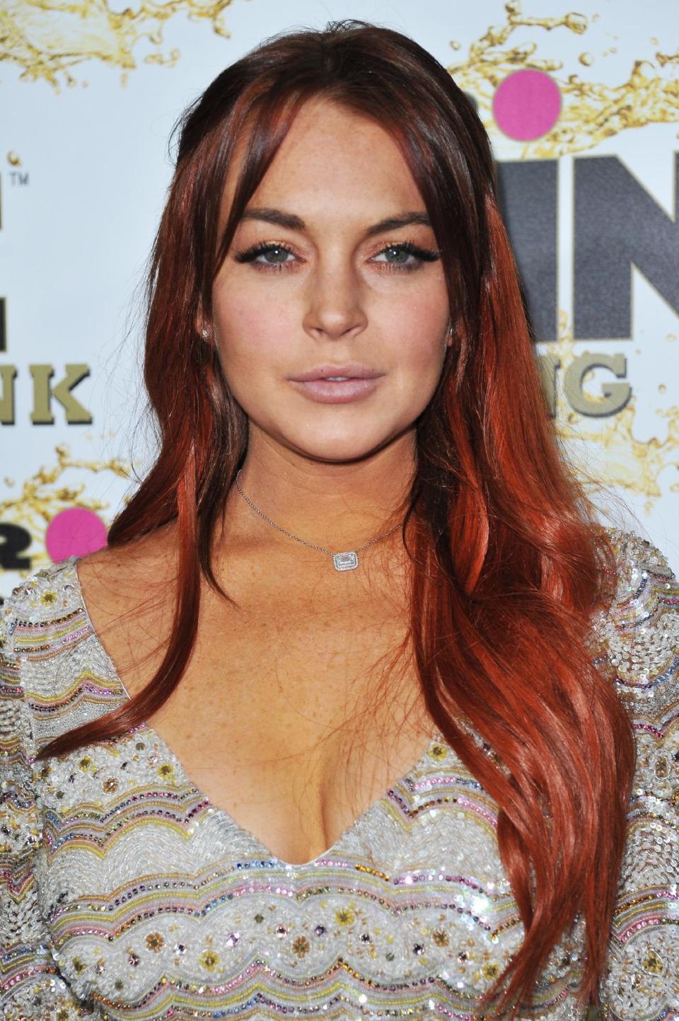 FILE - In this Oct. 11, 2012 file photo, Lindsay Lohan attends the Mr. Pink Ginseng launch party at the Beverly Wilshire hotel in Beverly Hills, Calif. Lohan is due to be arraigned on Wednesday, Dec. 12, 2012 on three misdemeanor charges filed after authorities say they determined the actress lied about being a passenger when her Porsche slammed into the back of a dump truck in June. (Photo by Richard Shotwell/Invision/AP, File)