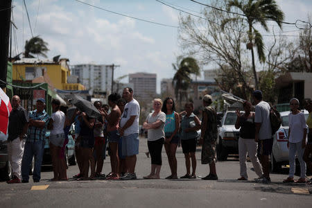 People wait in line for relief items to be distributed, after the area was hit by Hurricane Maria in San Juan, Puerto Rico September 24, 2017. REUTERS/Alvin Baez