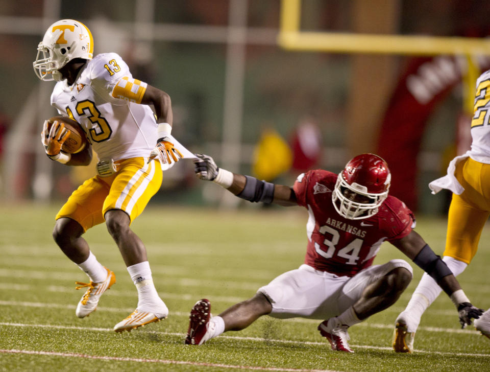 Nov 12, 2011; Fayetteville, AR, USA; Tennessee Volunteers wide receiver DeAnthony Arnett (13) gets past Arkansas Razorbacks linebacker Jerry Franklin (34) during the second half at Donald W. Reynolds Razorback Stadium. Mandatory Credit: Beth Hall-USA TODAY Sports