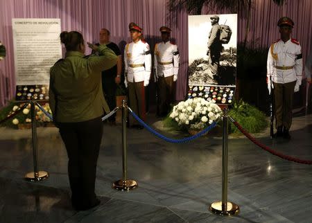 A woman salutes a tribute to Cuba's late President Fidel Castro at the Jose Marti Memorial in Revolution Square in Havana, Cuba, November 28, 2016. REUTERS/Stringer