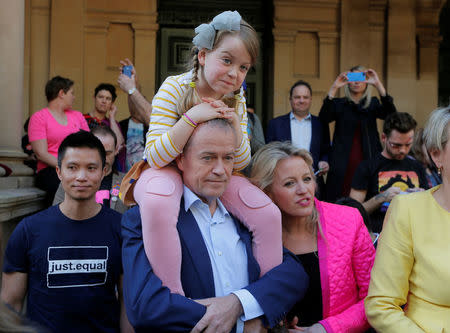 Australia's Labor Party opposition leader Bill Shorten shoulders his daughter Clementine alongside his wife Chloe before addressing a rally for marriage equality of same-sex couples in Sydney, Australia, September 10, 2017. REUTERS/Jason Reed