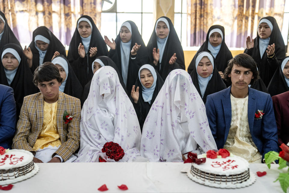 Afghan brides and grooms participate in a mass wedding ceremony during the International Women's Day, in Kabul, Afghanistan, Wednesday, March 8, 2023. (AP Photo/Ebrahim Noroozi)