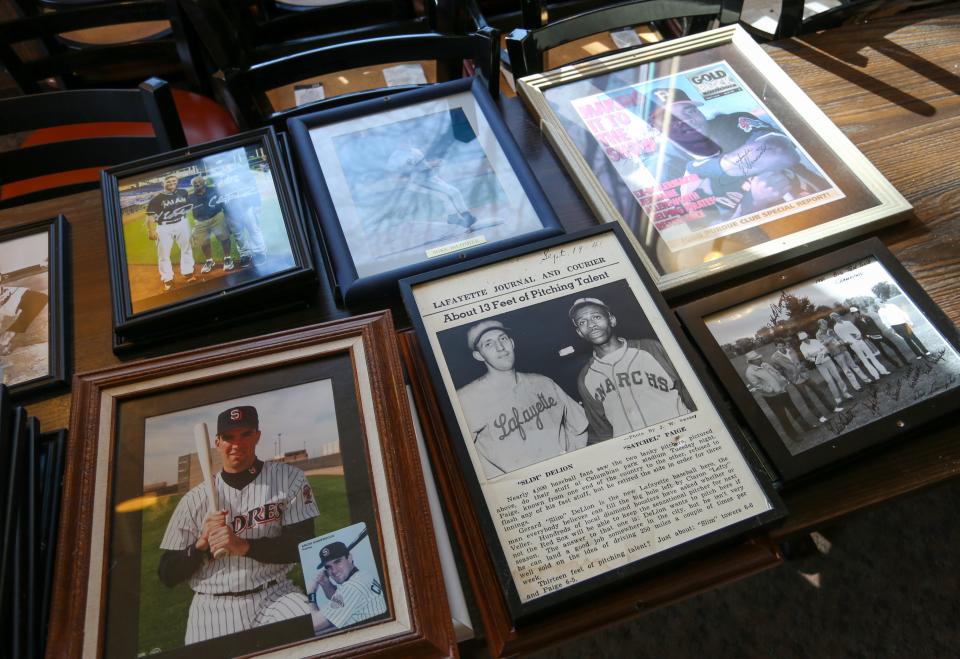 Purdue Unversity sports memorabilia sits on a table as people are removing memorabilia off the walls of Bruno's Pizza after officially closing their doors, on Thursday, Feb. 9, 2024, in West Lafayette Ind.