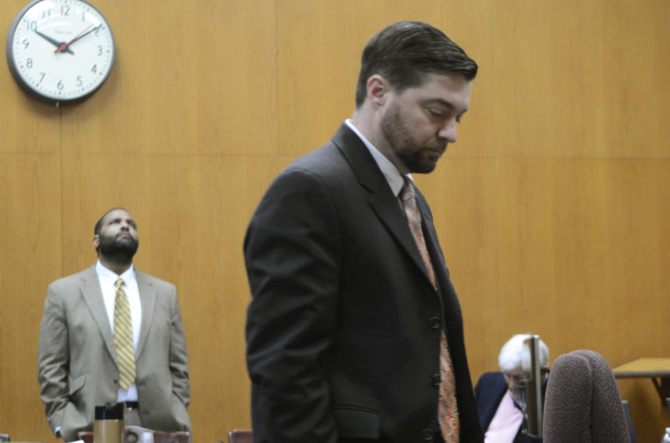 Assistant District Attorney Brendon Adams talks to the court reporter, unseen, during a break in testimony Friday, Feb. 21, 2020 while defendant Willie Cory Godbolt, left, waits for his attorneys on Day 7 of Godbolt's capital murder trial in the Pike County Courthouse in Magnolia, Miss. Godbolt, 37, is on trial, for the May 2017 shooting deaths of eight people in Brookhaven. (Donna Campbell/The Daily Leader via AP, Pool)