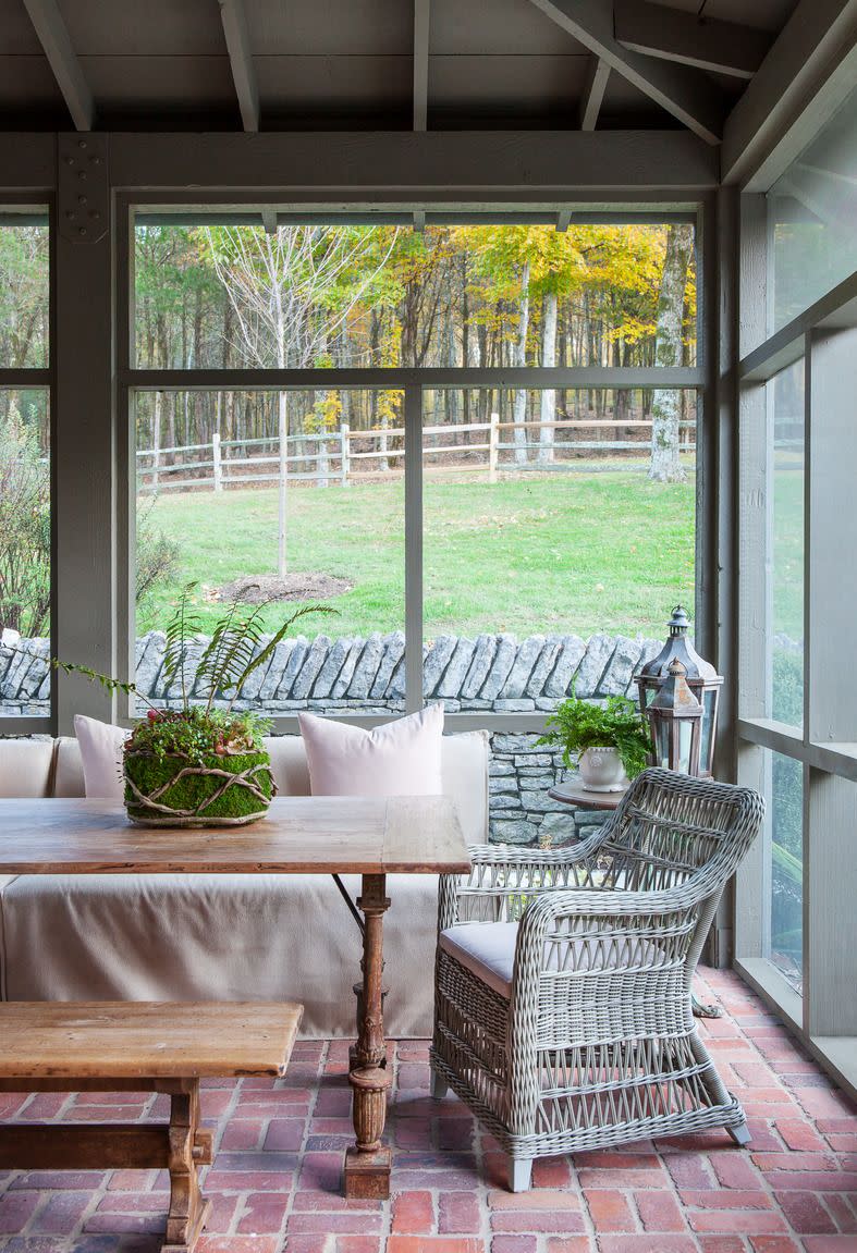 screened porch with sofa and table