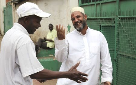 Clive Wanguthi (R), a Muslim leader, talks to a man near a mosque in Muslim-dominated Eastleigh neighbourhood in Kenya's capital Nairobi December 9, 2014. REUTERS/Katy Migiro