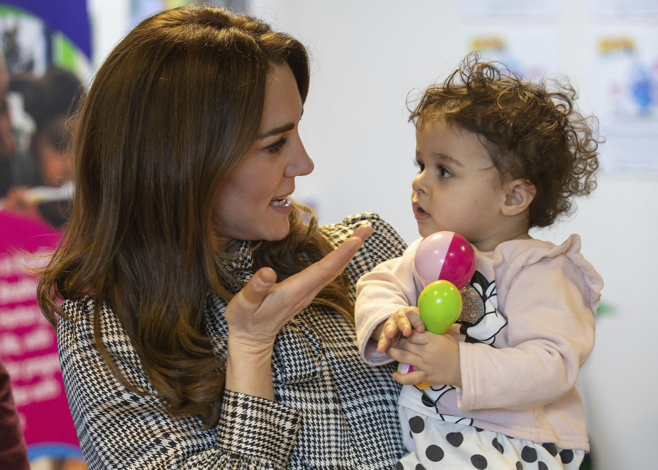 Britain's Kate, Duchess of Cambridge, talks with 18-month-old Sorayah Ahmad during a visit to a Khidmat Centre in Bradford, England, Wednesday, Jan. 15, 2020. (Charlotte Graham/Pool Photo via AP)