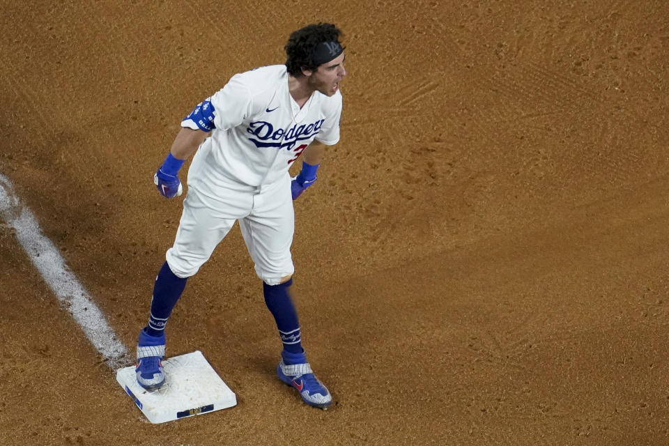 Los Angeles Dodgers' Cody Bellinger celebrates after a RBI-triple against the Atlanta Braves during the ninth inning in Game 2 of a baseball National League Championship Series Tuesday, Oct. 13, 2020, in Arlington, Texas. (AP Photo/David J. Phillip)