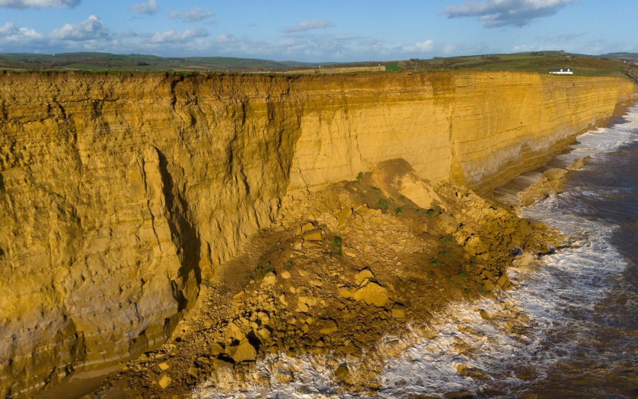 Aerial photos show boulders the size of double-decker buses resting on top of a 50ft pile of debris at Burton Bradstock