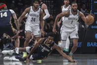 New Orleans Pelicans' Herbert Jones dives for a loose ball with Brooklyn Nets' Mikal Bridges during the first half of an NBA basketball game, Tuesday, March 19, 2024, in New York. (AP Photo/Bebeto Matthews)