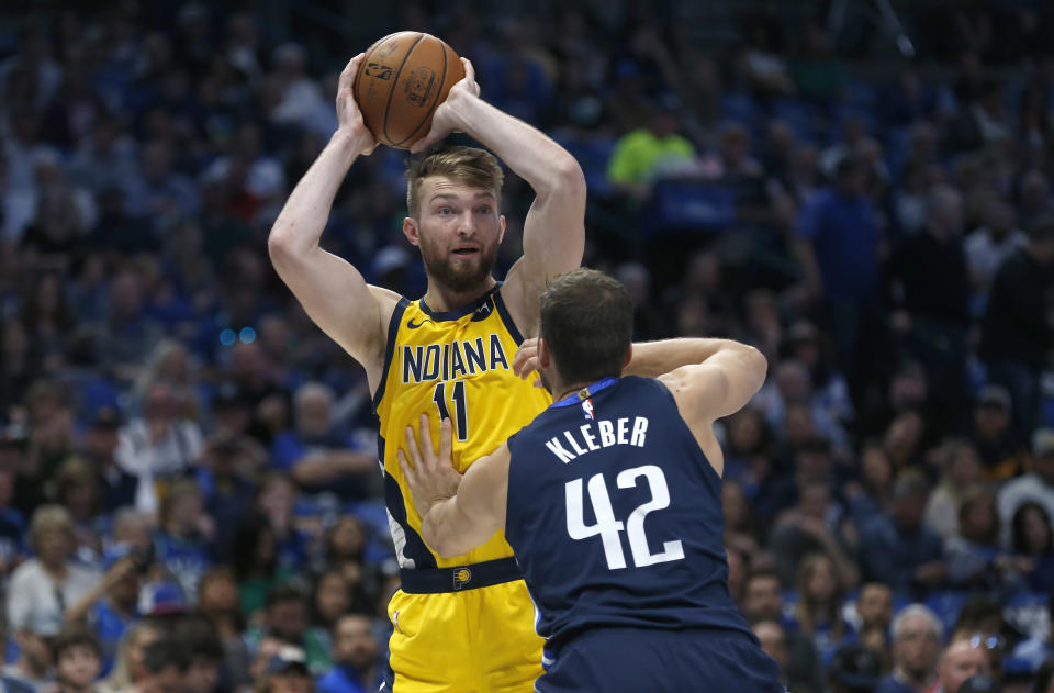 Indiana Pacers forward Domantas Sabonis (11) looks to pass over Dallas Mavericks forward Maxi Kleber (42) during the first half of an NBA basketball game, Sunday, March 8, 2020, in Dallas. (AP Photo/Ron Jenkins)