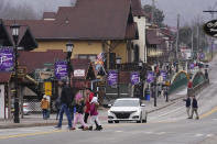 People cross the street in downtown Helen, Ga., Friday, Jan. 21, 2022. Helen is located in White County, in the foothills of the Blue Ridge Mountains in northeast Georgia, where officials were stunned when the 2020 census said the county had 28,003 residents. A Census Bureau estimate from 2019 had put the county's population at 30,798 people. (AP Photo/John Bazemore)