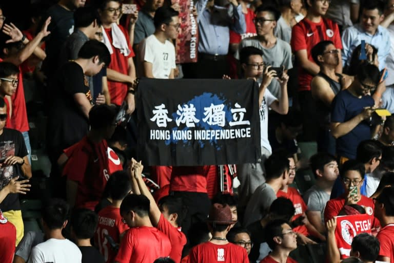 In this picture taken on October 10, 2017, a flag calling for "Hong Kong Independence" is displayed by local football fans during the playing of China's national anthem "March of the Volunteers" before a home match between Hong Kong and Malaysia