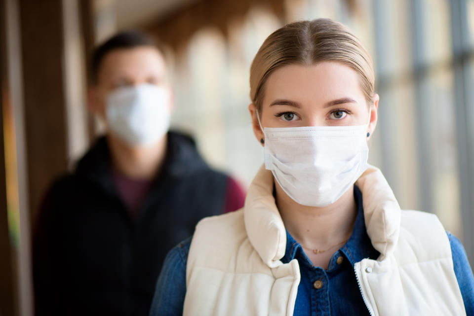 Man and woman wearing protective mask against transmissible infectious diseases and as protection against the flu. New coronavirus 2019-nCoV from China