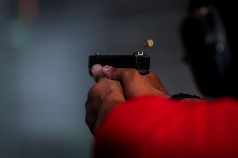 New York's Hudson Valley Nubian Gun Club founder Damon Finch fires his gun while teaching a shooting class at Master Class Shooting Range in Monroe, New York