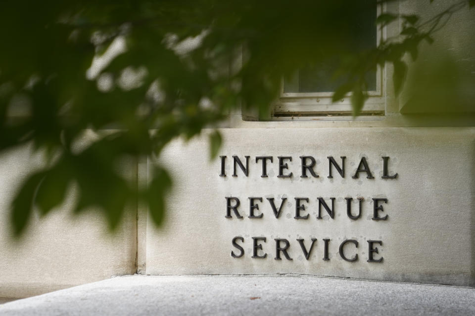 FILE - A sign is displayed outside the Internal Revenue Service building May 4, 2021, in Washington. On Friday, Aug. 19, 2022, The Associated Press reported on stories circulating online incorrectly claiming an online job ad shows that all new employees that the IRS intends to hire after a funding boost in the Inflation Reduction Act will be required to carry a firearm and use deadly force if necessary. (AP Photo/Patrick Semansky, File)