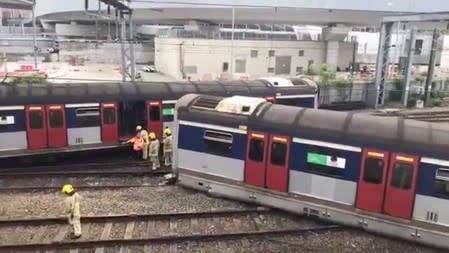 Emergency crew are seen at a derailed train wreckage near Hung Hom station on the MTR East Rail Line following an accident on a train bound for Mong Kok East in Hong Kong