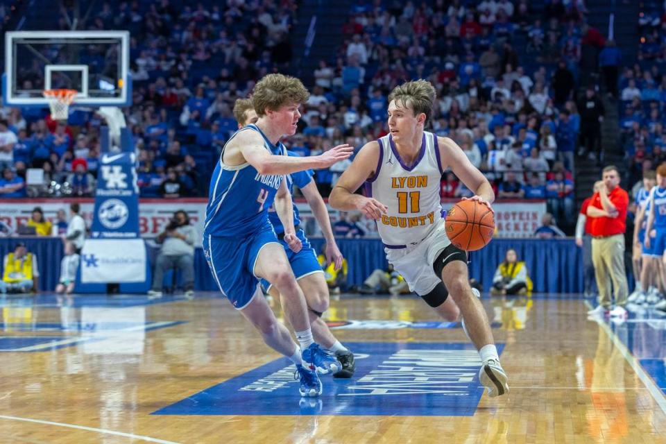 Lyon County’s Travis Perry (11) drives the ball as Adair County’s Carter White (4) plays defense during the UK HealthCare Boys’ Sweet 16 state basketball tournament at Rupp Arena in Lexington, Ky., on Friday, March 22, 2024. Perry led the Lyons to the state championship.