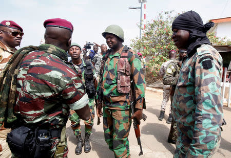 Lieutenant-Colonel Issiaka Ouattara, named Wattao, and Lieutenant-Colonel Cherif Ousmane greet mutinous soldiers, at the airport in Bouake, Ivory Coast January 13, 2017. REUTERS/Thierry Gouegnon