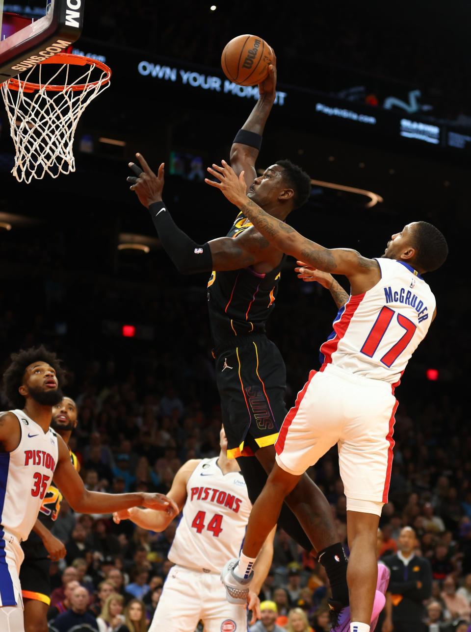 Nov 25, 2022; Phoenix, Arizona, USA; Phoenix Suns center Deandre Ayton (22) slam dunks the ball against Detroit Pistons guard Rodney McGruder (17) in the first half at Footprint Center.