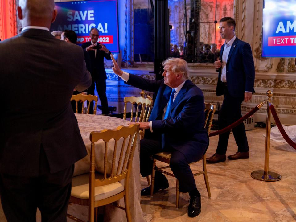 Former President Donald Trump waves to guests as he takes a seat at Mar-a-lago on Election Day, Tuesday, Nov. 8, 2022, in Palm Beach, Fla.