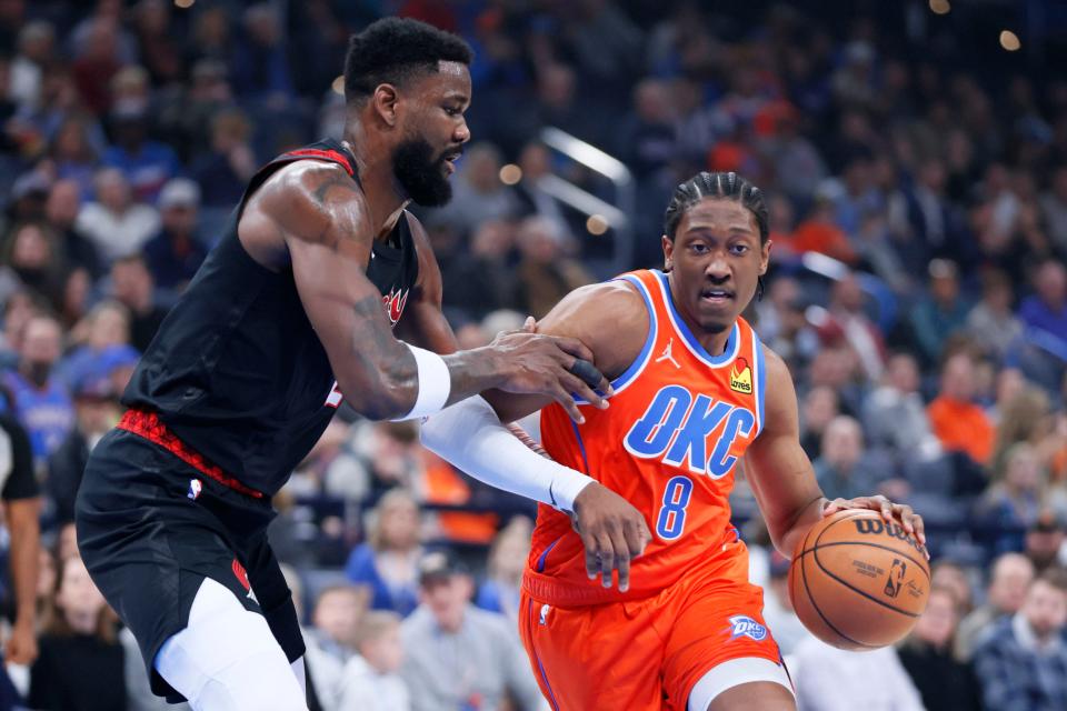 Oklahoma City Thunder forward Jalen Williams (8) goes past Portland Trail Blazers center Deandre Ayton (2) during an NBA basketball game between the Oklahoma City Thunder and the Portland Trail Blazers at Paycom Center in Oklahoma City, Tuesday, Jan. 23, 2024.