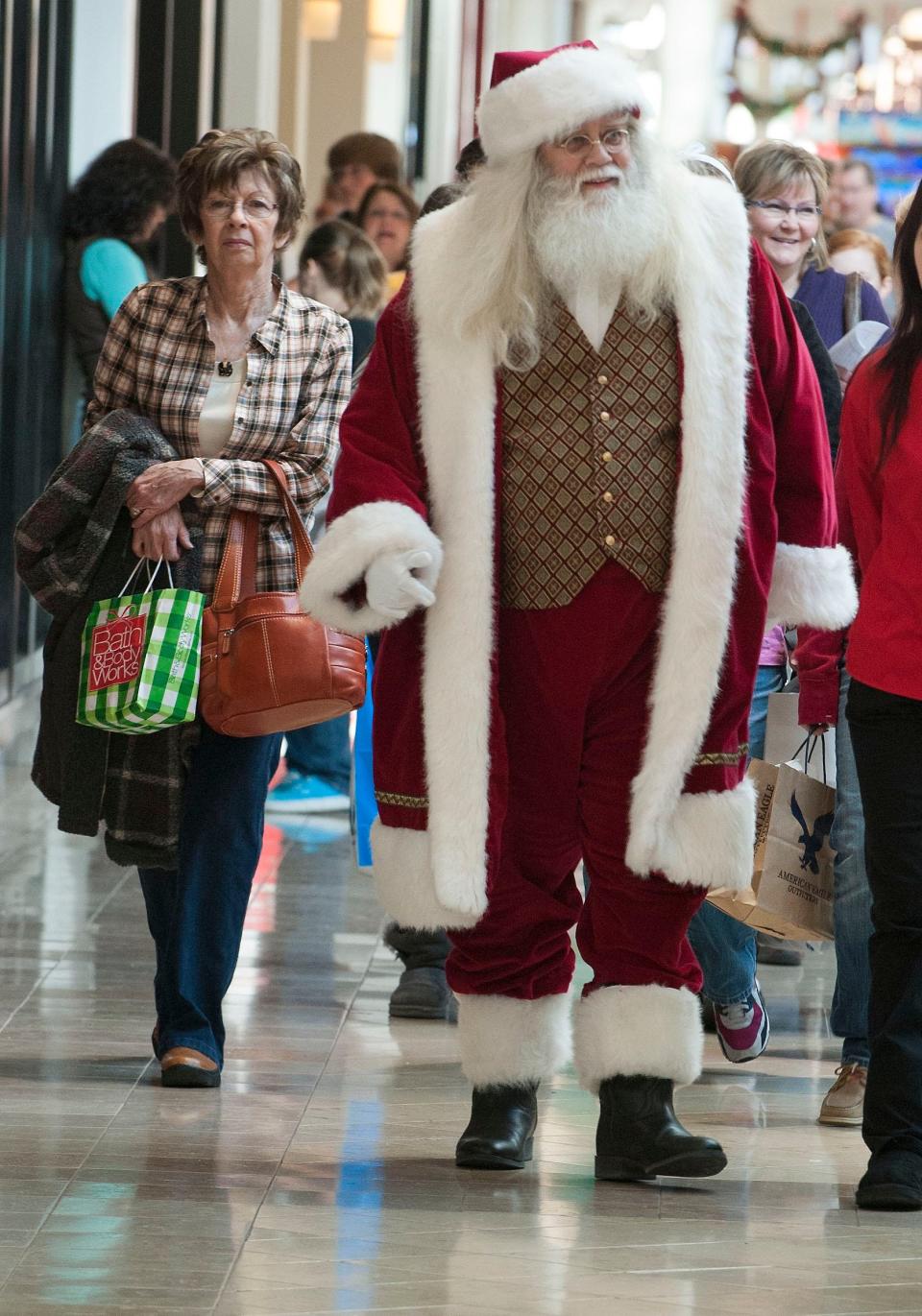 Santa Claus walks though West Town Mall with Black Friday shoppers.