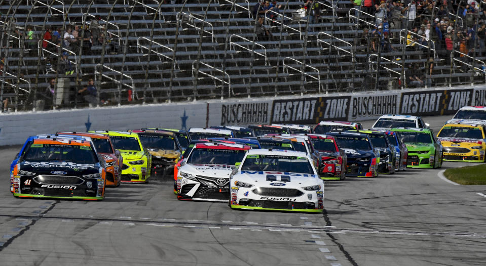 Kurt Busch (41) and Kevin Harvick (4) lead the pack down the front stretch on a restart during a NASCAR Cup auto race at Texas Motor Speedway, Sunday, Nov. 4, 2018, in Fort Worth, Texas. (AP Photo/Larry Papke)