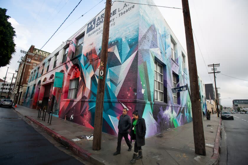 Los Angeles, CA., December 4, 2019: People walk past Art Share L.A. on Wednesday December 4, 2019. the art center and nonprofit provides affordable housing and studio space to working L.A. artists and its gallery space is filled with a wonderfully chaotic collection of work that feels raw, real and approachable. Four hours in downtown Los Angeles' Arts District features a wide variety of eclectic destinations that are great to visit on Wednesday December 4, 2019. (Jason Armond / Los Angeles Times)