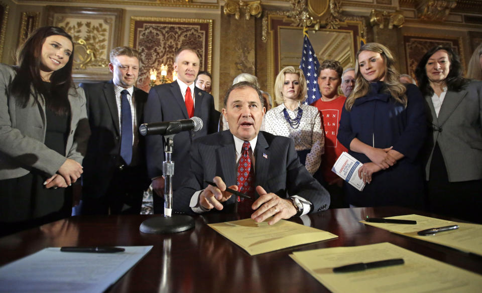 FILE - In this April 19, 2016, file photo, Utah Gov. Gary Herbert looks up during a ceremonial signing of a state resolution declaring pornography a public health crisis, at the Utah State Capitol, in Salt Lake City. More than a dozen states have moved to declare pornography a public health crisis, encouraging supporters but raising concerns among experts who say the label goes too far and carries its own risks. Arizona became the latest of 16th state to pass a resolution in at least one legislative chamber on Monday, May 6, 2019, calling for a systemic effort to prevent exposure to porn that's increasingly accessible to kids at younger ages online. (AP Photo/Rick Bowmer, File)