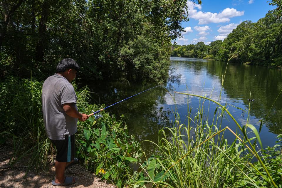 Junior Jimenez fishes near the Ann and Roy Butler Hike and Bike Trail on the north side of Lady Bird Lake on Saturday. Since the Holly Power Plant was shut down, the area has been more peaceful.