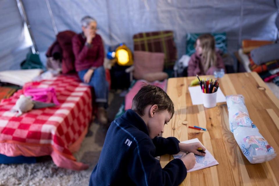 Petro, 7, and his family received support in a Caritas welcome tent (Toby Madden/DEC)