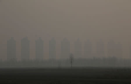 FILE PHOTO: Residential buildings under construction are pictured on a polluted day after the Chinese Lunar New Year holidays on the outskirts of Langfang, Hebei province, China, February 3, 2017. REUTERS/Jason Lee/File Photo