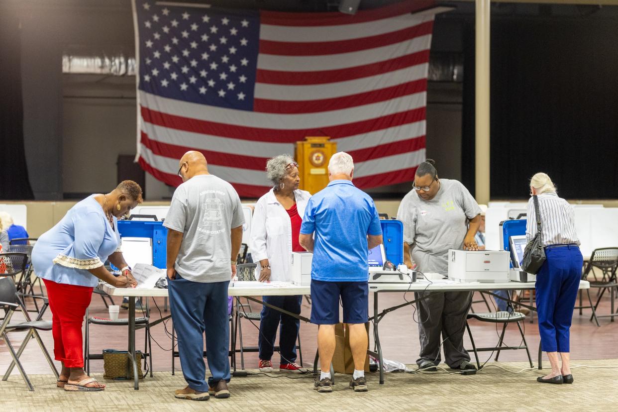 Voters sign in to vote at Brandon City Hall in Brandon, Miss., during the primary election Tuesday, Aug. 8, 2023.