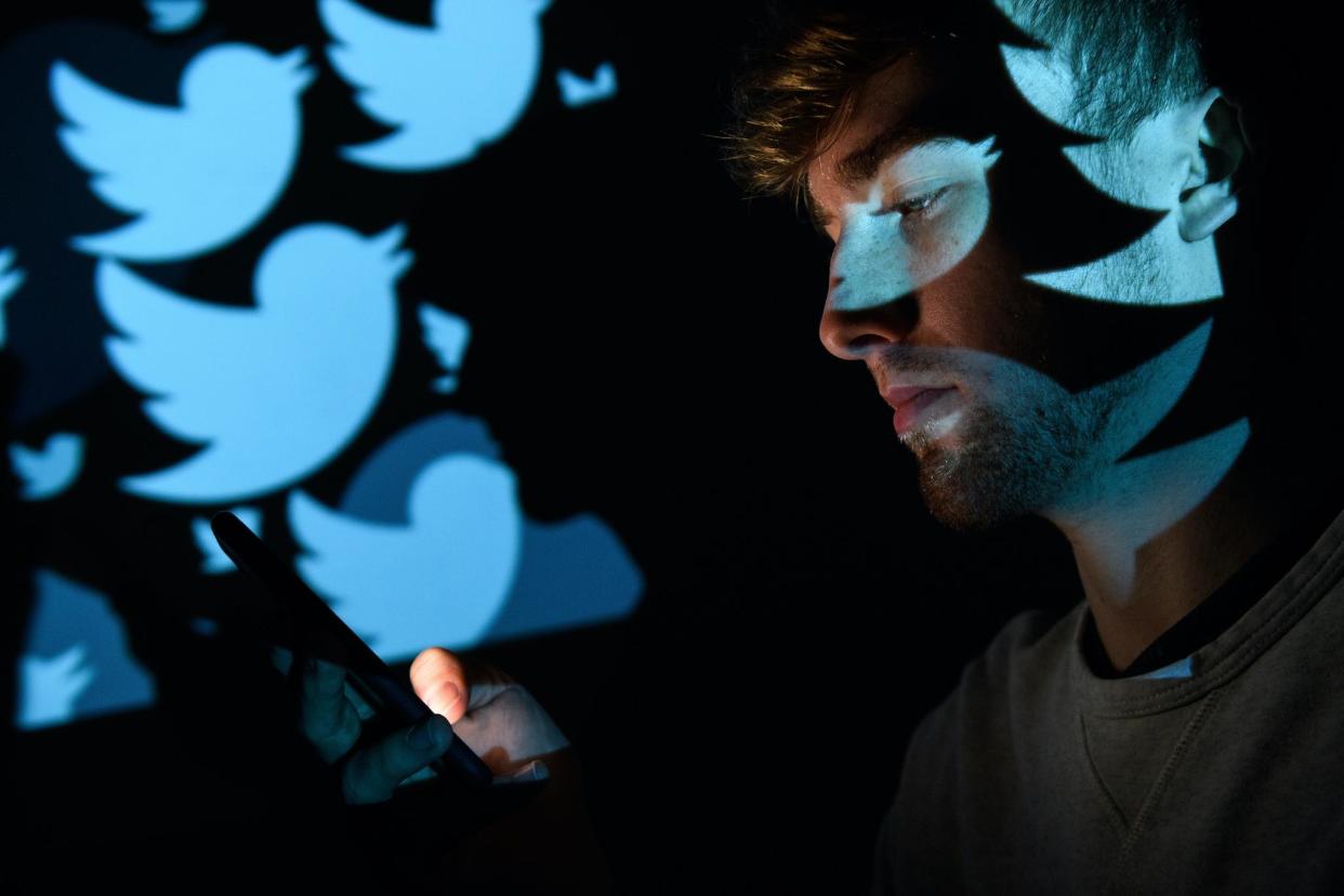 In this photo illustration, the logo for the Twitter social media network is projected onto a man on August 09, 2017 in London, England: Leon Neal/Getty Images