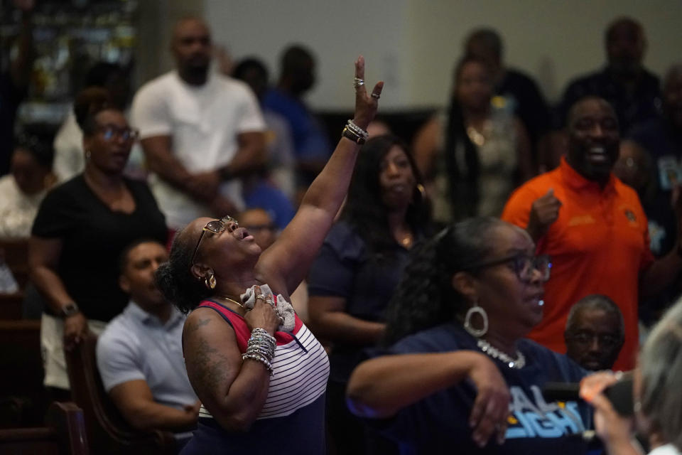 FILE - A woman sings during a prayer vigil at Salt and Light church for the victims of a fatal Monday night shooting spree, Wednesday, July 5, 2023, in Philadelphia. A 40-year-old killed one man in a house before fatally shooting four others on the streets of a Philadelphia neighborhood, then surrendering along with a rifle, a pistol, extra magazines, a police scanner and a bulletproof vest, police said. (AP Photo/Matt Slocum, File)